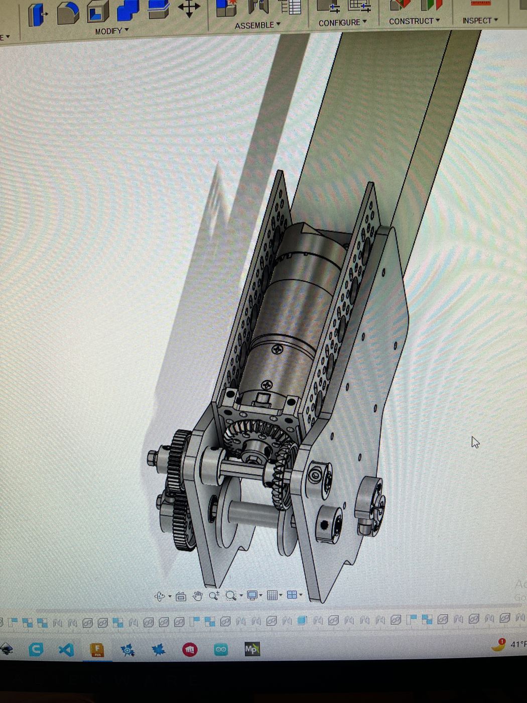 CAD of the geared drive: motor and spur-gear reduction packaged between perforated FTC channel.