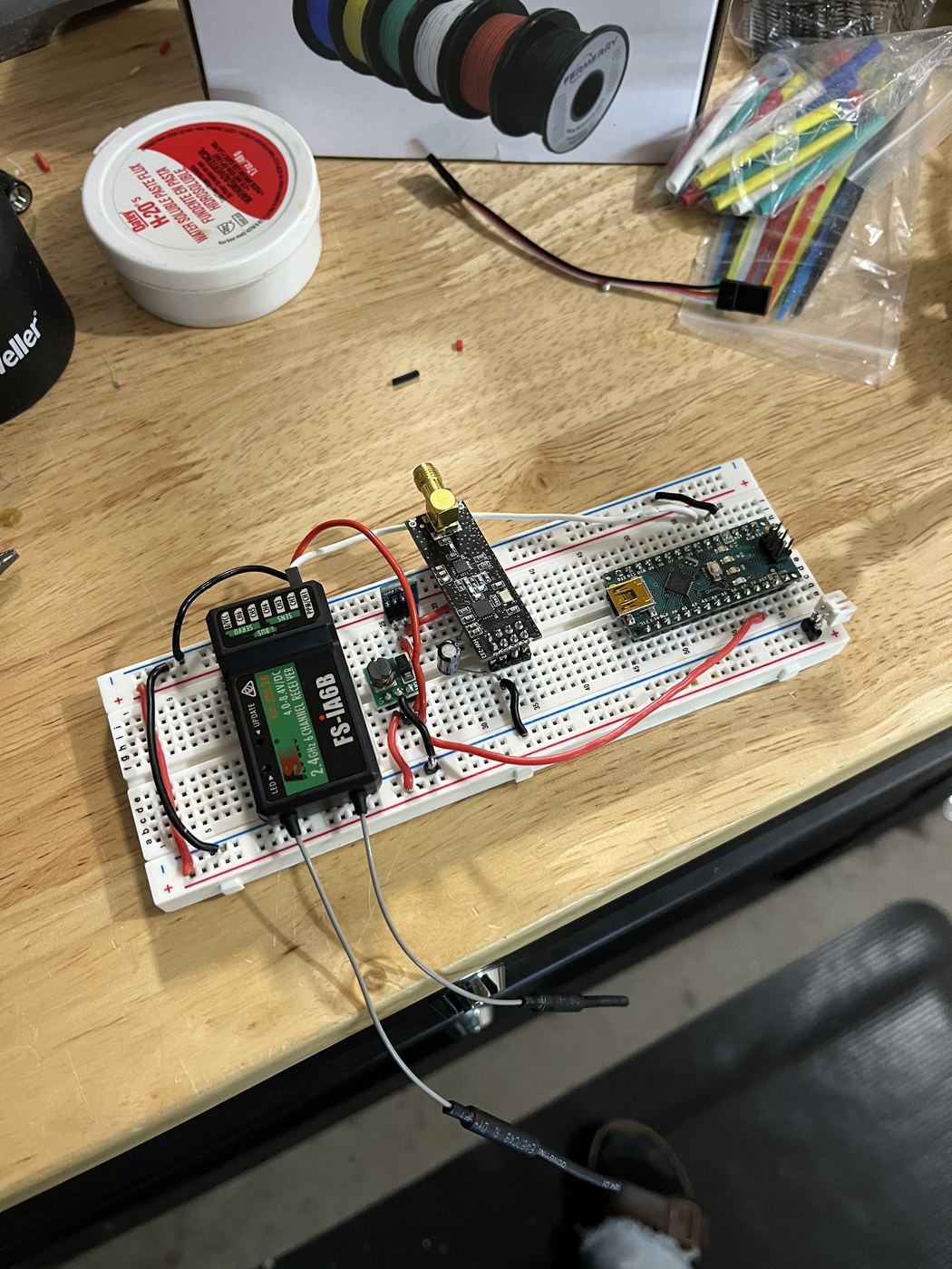 Relay electronics on the bench: FS-iA6B receiver, nRF24L01+ transceiver, and Arduino Nano on the breadboard.